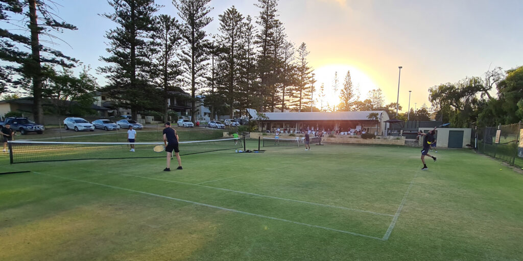 Allen Park tennis courts at sunset with members playing